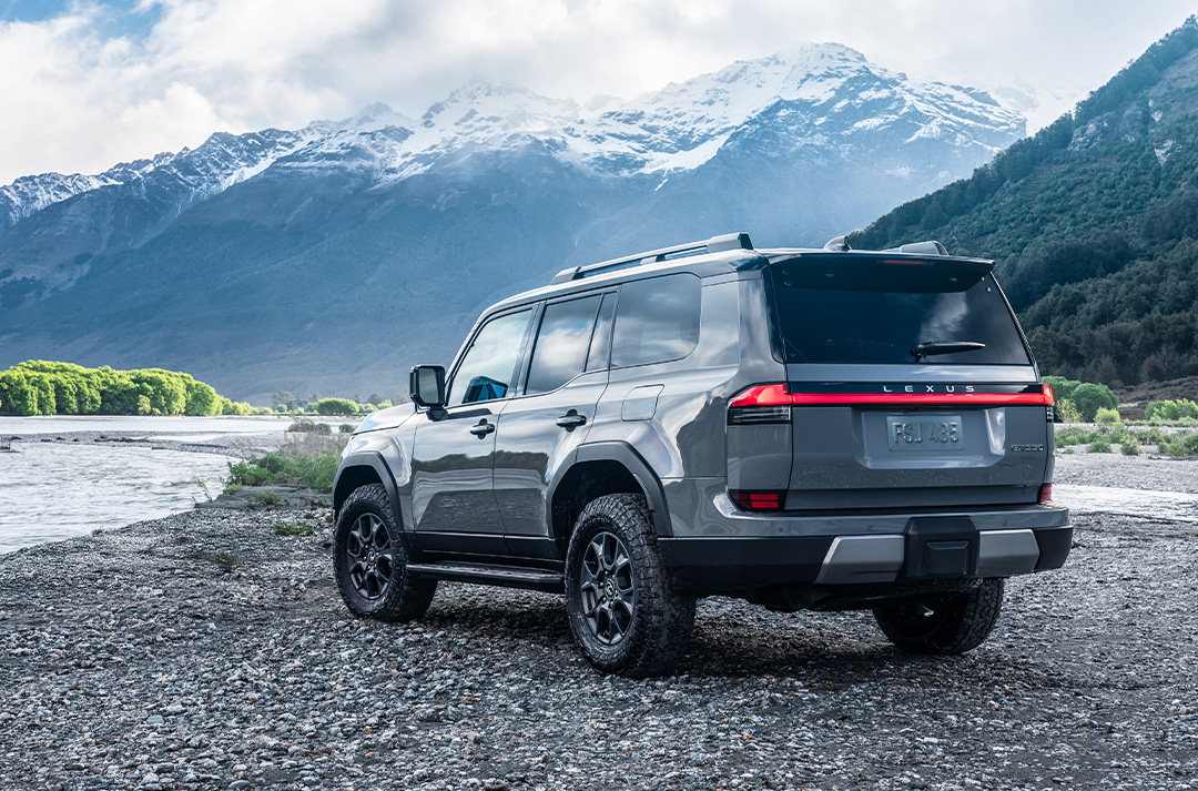 Lexus GX driving off-road amongst snowcapped mountains