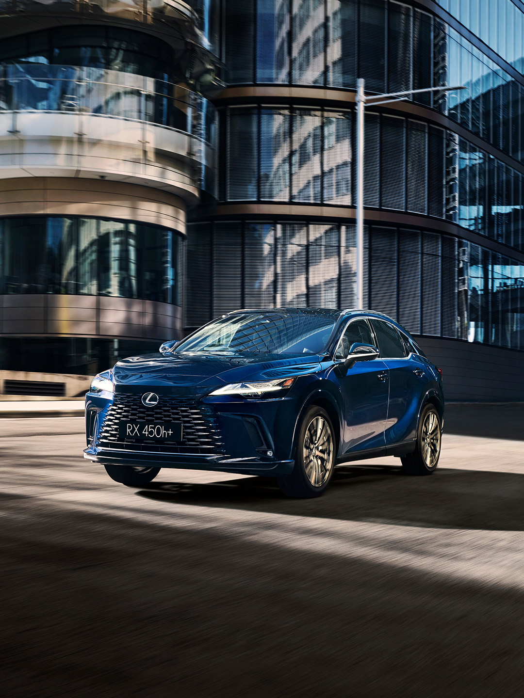 Lexus RX 450h+ driving in the city